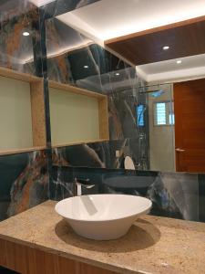 a bathroom with a bowl sink on a counter at The Paradise Kingdom in Kanchipuram +51 photos