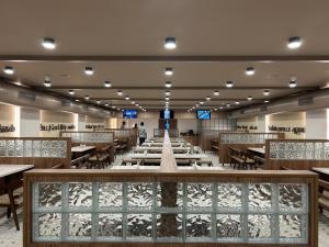 a large dining room with tables and chairs at The Paradise Kingdom in Kanchipuram
