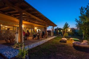 a group of people sitting outside of a building at Agriturismo Quartuccio in Oricola