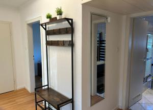 a mirror on a wall next to a room at Wohnung in Neuss - nähe Düsseldorf in Neuss +11 photos