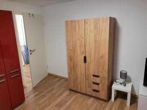 a room with a large wooden cabinet and a table at Charlotte II in Neustadt bei Coburg