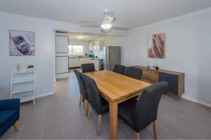 a dining room with a wooden table and chairs at Diamond Hills Campbell Town in Campbell Town