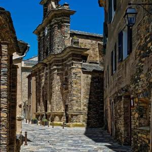 an old stone building with a clock tower at Casa Pernice in Penta-di-Casinca