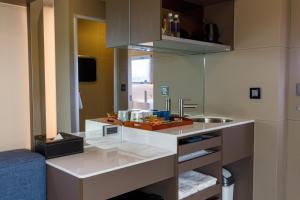 a small kitchen with a sink and a counter at Bay Hill Camping Area in Magong