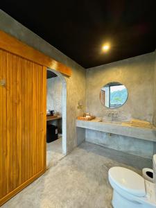 a bathroom with a toilet and a sink at La Varuna Kintamani and Hot Spring in Kintamani +37 photos