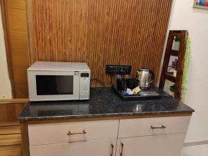 a kitchen with a microwave on a counter at Nestle Luxury Homes 1 in Lucknow