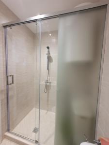 a shower with a glass door in a bathroom at Smokinia Sunrise - Kavatsi Beach, Sozopol in Sozopol