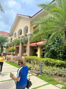 a woman is taking a picture of a building at Sanremo Oasis Condo in Cebu City