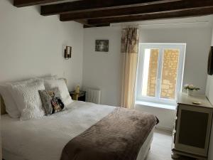 a bedroom with a large bed and a window at Maison Centre de Loches in Loches