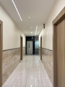 a hallway of an office building with doors and tile floors at Hotel Shreegopal in Ujjain +19 photos