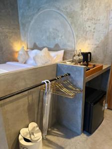 a room with a bed and a desk with a sink at La Varuna Kintamani and Hot Spring in Kintamani