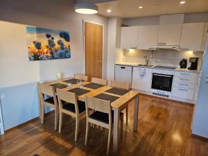 a kitchen with a table and chairs in a room at Ruka Chalets Ski-In 1313 in Ruka