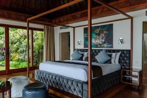 a bedroom with a large bed with a canopy at The Edge Bali in Uluwatu +83 photos