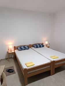 a large bed in a room with two lamps at Adamovic in Pirot