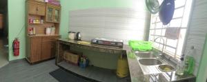 a kitchen with a sink and a counter top at Dinaz Homestay Taman Limbungan Permai Melaka in Melaka