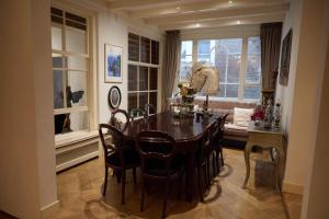 a dining room with a table and chairs and a window at redlight canalview city centre in Amsterdam