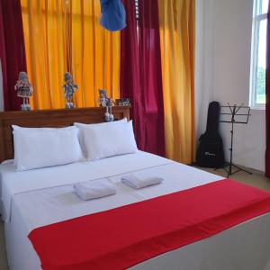 a bedroom with a bed with colorful curtains at Guest house weherahena in Matara