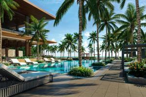 Una piscina tipo resort con palmeras y tumbonas. en Donoma Las Terrenas Beach Hotel & Spa, Autograph Collection, en Las Terrenas