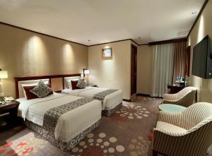 Voodi või voodid majutusasutuse Macau Masters Hotel toas