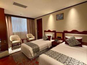 Voodi või voodid majutusasutuse Macau Masters Hotel toas