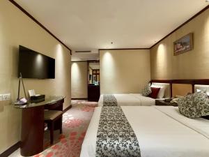 Voodi või voodid majutusasutuse Macau Masters Hotel toas