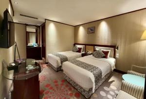 Voodi või voodid majutusasutuse Macau Masters Hotel toas