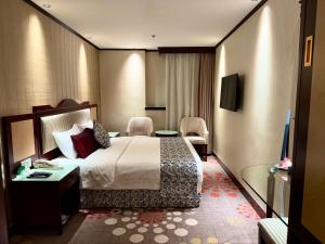 Voodi või voodid majutusasutuse Macau Masters Hotel toas