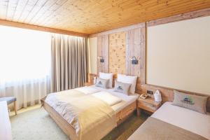 a bedroom with a bed and a large window at Hotel Styrolerhof in Steeg +37 photos