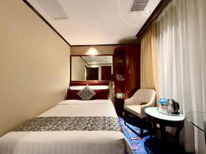 Voodi või voodid majutusasutuse Macau Masters Hotel toas