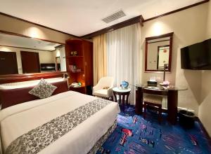 Postel nebo postele na pokoji v ubytování Macau Masters Hotel