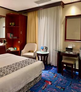 Voodi või voodid majutusasutuse Macau Masters Hotel toas