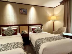 Voodi või voodid majutusasutuse Macau Masters Hotel toas