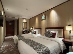 Voodi või voodid majutusasutuse Macau Masters Hotel toas
