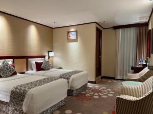 Voodi või voodid majutusasutuse Macau Masters Hotel toas