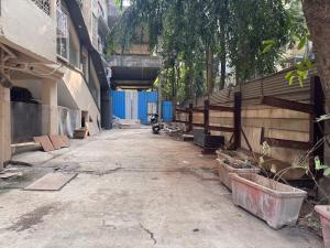 an empty alley with a building and a blue fence at Hotel West Line Andheri in Mumbai