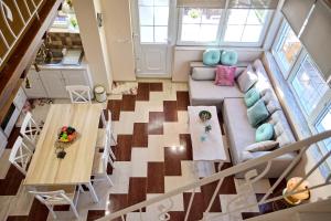 an overhead view of a living room with a couch and a table at Sweet Cottage In The City in Chios