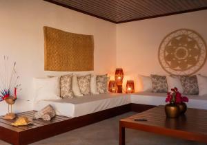 a living room with two beds and a table at Kite Oasis Parajuru Villa Palmeira in Parajuru +35 photos
