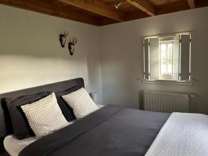 a bedroom with a large bed and a window at Natuurhuisje het Steenuiltje op een prachtige plek in Wekerom +44 photos