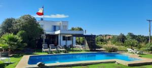 a house with a swimming pool in the yard at Ensueño de Rapel , Costa del Sol in La Estrella