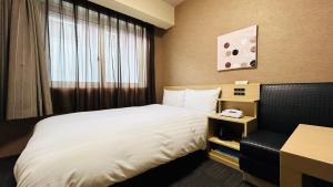 Postel nebo postele na pokoji v ubytování ​Hotel Route-Inn Kumagaya​