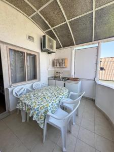 a kitchen with a table and chairs and a sink at Heaven Apartments in Ulcinj +28 photos