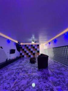 a living room with purple lighting and a couch at Shiri Hotel Pool Villa 3 쉬리호텔 풀빌라 3 in Lalaan Primero