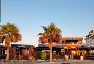 a building with palm trees in front of it at Kmi in Zarzis
