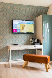 a living room with a tv on a wall at Hus Mattgoot - Doppelzimmer No.2 in Böhl +8 photos