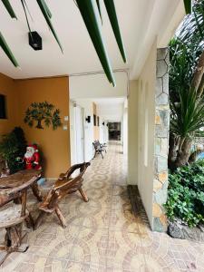 a hallway with benches and plants in a building at Alta Montana One Hotspring Resort Mt Makiling View in Forestry