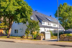 a white house with a tree in front of it at Hus Mattgoot - Doppelzimmer No.2 in Böhl