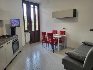 a kitchen and living room with a table and chairs at Casa Valeria in Sulmona