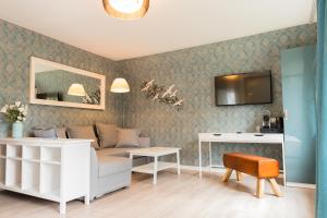a living room with a couch and a table at Hus Mattgoot - Doppelzimmer No.2 in Böhl