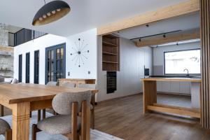 a kitchen and dining room with a table and a clock at Chalet Pamporovo in Pamporovo