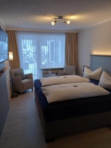 Ein Bett oder Betten in einem Zimmer der Unterkunft Mein Vierjahreszeiten Hotel Garni Superior